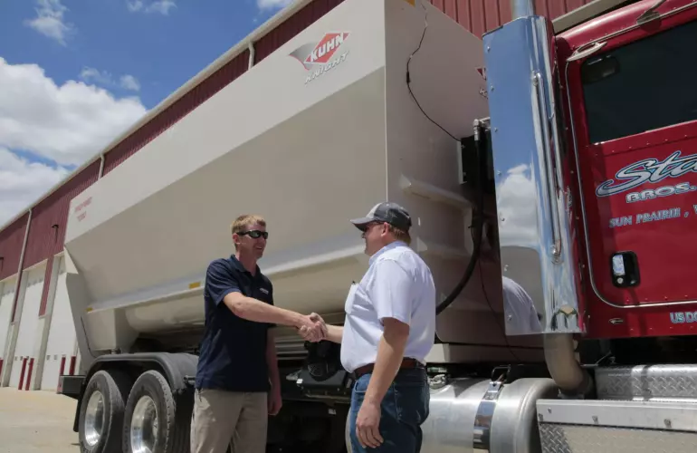 Dealer shaking hands with a customer.