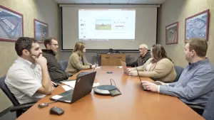 kuhn employees meeting in a conference room