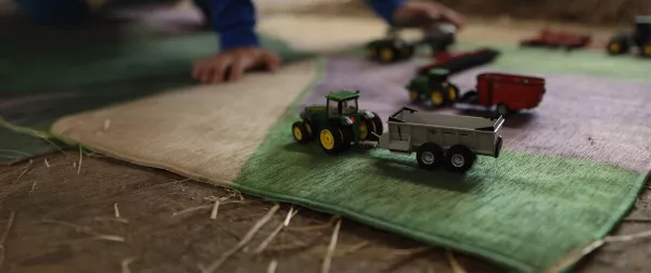 KUHN scale model toys on a carpet